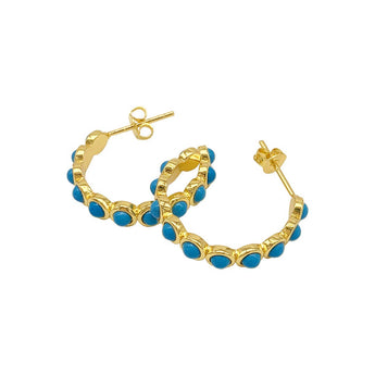 These Bezeled Turquoisette Hoop Earrings are crafted with 14k yellow gold vermeil over brass and feature a secure post-back closure. Their 1" diameter and 4mm width make them perfect for any occasion.