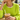 Woman wearing the Gold Bow Choker with a chartreuse sweater, holding an iced coffee