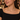 Woman in a black off-the-shoulder top wearing the gold crystal tennis necklace at dinner