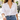 Open Hamsa Necklace in gold worn with a white button-down shirt and jeans