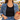 Lexi Necklace in gold and white enamel worn with a black tank and denim jacket at a farmers market