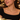 Gold crystal tennis necklace layered with a delicate gold chain, worn with a black top at dinner