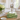 Palm leaf acrylic bowl on woven coffee table with hydrangeas