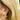 Aviva gold leaf earring worn on the ear with blonde hair
