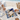 Two players at a butterfly acrylic backgammon board on the beach