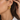Woman wearing the Carrie triple gold hoop earring with white shirt