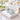 Champagne bucket napkin weight on napkins beside coupe glasses
