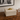 Cream leather box with gold ball handle on wood console