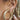 Hand touching an ear stack with chunky and pavé gold hoops