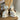 White ceramic spotted dog salt and pepper shakers on a wood board