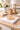 Equestrian round napkin weight on books on a desk