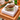 Football acrylic napkin weight on napkins on a wicker table