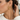 Woman with a low bun wearing a gold cable hoop earring