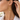 Woman in a white shirt wearing a gold heart charm hoop