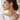 Woman with an elegant updo wearing gold pear droplet earrings