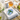 Hydrangea napkin weight on napkins beside a cheese and grape spread