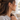 Woman in a gray sweatshirt wearing a Lotus chain hoop earring