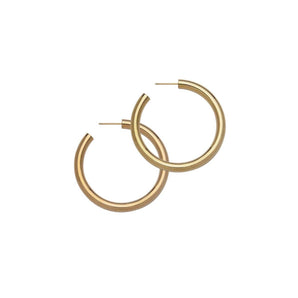 These classic 2" hoops are cast in various shiny metal options with a thick tubular silhouette for the ultimate in versatility.    An everyday earring essential sized perfectly to pair with your favorite top, whether it’s a high or low neckline.       - 14k yellow gold-plated silver - 2" diameter - Approximate thickness: 5mm - Approximate weight: 6 grams - Post back