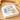Mahjong tile napkin weight on white napkins on a rattan tray