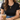 Gold pearl and coin toggle necklace worn with a black tee and jeans at a cafe