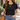 Woman wearing the gold pearl and coin toggle necklace with a black tee, jeans, and a brown leather tote