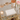 Scalloped acrylic holder with napkins on bar cart with rose wine
