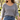 Shira double-layer gold necklace worn with a grey knit sweater and jeans