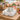 White roses napkin weight on napkin holder with rosé glasses